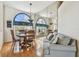 Cozy dining room with hardwood floors, large window, and mirrored wall for added depth at 9219 Irondale Ln, Hudson, FL 34667