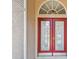 Inviting front entrance with double glass doors and sunburst transom window at 9219 Irondale Ln, Hudson, FL 34667