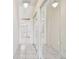 Hallway with closet and access to bathroom with tub, shower, and toilet at 9219 Irondale Ln, Hudson, FL 34667