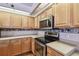 Kitchen with stainless steel appliances and wood cabinets at 9219 Irondale Ln, Hudson, FL 34667