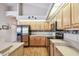 Kitchen featuring stainless appliances, wood cabinets, and plenty of counter space at 9219 Irondale Ln, Hudson, FL 34667
