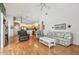 Spacious living room with hardwood floors, open layout, and views into the kitchen at 9219 Irondale Ln, Hudson, FL 34667