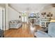 Open living room area featuring lots of seating, natural light, and hardwood flooring throughout at 9219 Irondale Ln, Hudson, FL 34667