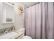 Bathroom features granite countertops, modern fixtures, decorative mirror, and shower with patterned curtain at 9616 56Th N St, Pinellas Park, FL 33782