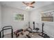 This bedroom features a ceiling fan and natural light coming from two windows at 9616 56Th N St, Pinellas Park, FL 33782