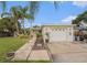 Charming single-story home with lush landscaping and a well-maintained front yard and a one car garage at 9616 56Th N St, Pinellas Park, FL 33782