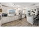 Modern kitchen with white cabinets, stainless steel appliances, granite countertops and wood style tile flooring at 9616 56Th N St, Pinellas Park, FL 33782