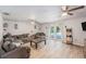 Bright living room features wood floors, comfortable seating and sliding glass doors to a private backyard pool at 9616 56Th N St, Pinellas Park, FL 33782