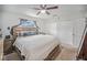 Main bedroom features multiple closets, carpeted floors, ceiling fan and natural light from a window at 9616 56Th N St, Pinellas Park, FL 33782