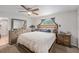 Cozy main bedroom features a wooden bed frame, soft white bedding, and wooden furniture at 9616 56Th N St, Pinellas Park, FL 33782