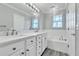 Bright bathroom features double vanity, soaking tub, decorative lighting, and wood-look tile at 113 Bosphorous Ave # 5, Tampa, FL 33606