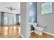 Bathroom showcasing sink, toilet, and hardwood floors, with a living area in the background at 113 Bosphorous Ave # 5, Tampa, FL 33606