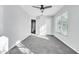 Sunny bedroom featuring plush carpeting, a ceiling fan, and a large window at 113 Bosphorous Ave # 5, Tampa, FL 33606