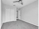 Cozy bedroom featuring plush carpeting, ceiling fan, and a spacious closet for ample storage at 113 Bosphorous Ave # 5, Tampa, FL 33606