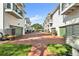 Exterior view of townhomes with red brick drive and green garages at 113 Bosphorous Ave # 5, Tampa, FL 33606