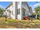 Back exterior of a two-story home with white siding, black railings, and a well-maintained grassy yard at 113 Bosphorous Ave # 5, Tampa, FL 33606