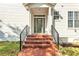 Inviting front entrance featuring a green door, brick steps and black railings of this two-story residence at 113 E Bosphorous Ave # 5, Tampa, FL 33606