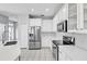 Modern kitchen with stainless steel appliances, white cabinets, and subway tile backsplash at 113 Bosphorous Ave # 5, Tampa, FL 33606