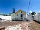Quaint backyard with brick paved ground and charming light yellow exterior, ideal for outdoor living at 13326 1St E St, Madeira Beach, FL 33708