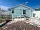 Exterior backyard featuring brick ground, small garden and light blue siding of this lovely home at 13326 1St E St, Madeira Beach, FL 33708