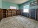 Bedroom requiring restoration, showcasing exposed wall studs, windows, and paint at 13326 1St E St, Madeira Beach, FL 33708