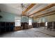 Open-concept living room requiring restoration, featuring exposed beams and natural light at 13326 1St E St, Madeira Beach, FL 33708