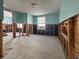 Interior room needs remodeling, featuring exposed wall studs, a window, and blue walls at 13326 1St E St, Madeira Beach, FL 33708