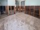Spacious room awaiting remodeling, featuring exposed wall studs and an open floor plan at 13326 1St E St, Madeira Beach, FL 33708