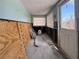 Bright room interior needing remodeling, showcasing a window, door and plywood at 13326 1St E St, Madeira Beach, FL 33708