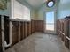 Interior room needing renovation, showcasing a window, plumbing and exterior door at 13326 1St E St, Madeira Beach, FL 33708