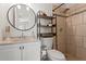 Well-lit bathroom featuring a modern sink, shelving and tiled shower at 13751 Juniper Blossom Dr, Tampa, FL 33618