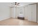 Bright bedroom with ample closet space, neutral colors, ceiling fan, and a comfortable ottoman bench at 13751 Juniper Blossom Dr, Tampa, FL 33618