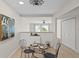 Inviting dining area with stylish decor, neutral tones and an open view to the living area with natural light at 13751 Juniper Blossom Dr, Tampa, FL 33618
