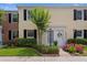 Charming townhome featuring a white door, manicured landscaping, and black shutters for added curb appeal at 13751 Juniper Blossom Dr, Tampa, FL 33618