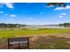 Beautiful lake view with a bench and blue skies at 13751 Juniper Blossom Dr, Tampa, FL 33618