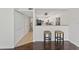 Inviting living space showcasing hardwood floors and a view into the bright and airy kitchen at 13751 Juniper Blossom Dr, Tampa, FL 33618