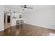 Inviting living space showcasing hardwood floors and a view into the bright and airy kitchen at 13751 Juniper Blossom Dr, Tampa, FL 33618