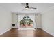 Serene room with sliding door to the patio that features two chairs overlooking a peaceful waterfront view at 13751 Juniper Blossom Dr, Tampa, FL 33618