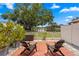 Relaxing patio featuring two chairs, red brick, and a beautiful view of the waterfront at 13751 Juniper Blossom Dr, Tampa, FL 33618