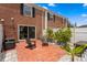 Charming brick patio with black adirondack chairs and lush plantings at 13751 Juniper Blossom Dr, Tampa, FL 33618