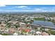 An aerial view of the property and surrounding neighborhood, showcasing the nearby lake and community amenities at 13821 Joyce Dr, Largo, FL 33774