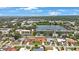 Neighborhood aerial view showcasing the community, lake and green spaces, close to shops and other conveniences at 13821 Joyce Dr, Largo, FL 33774