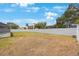Large, fenced backyard with lush green grass and space for outdoor enjoyment at 13821 Joyce Dr, Largo, FL 33774