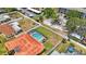 An aerial view of the backyard featuring a screened-in pool, fenced yard, and tropical landscaping at 13821 Joyce Dr, Largo, FL 33774