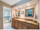 Bathroom with double vanity, granite countertop and a separate toilet area at 13821 Joyce Dr, Largo, FL 33774