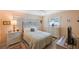 Cozy bedroom with neutral tones and a large window offering natural light at 13821 Joyce Dr, Largo, FL 33774