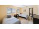 Bright bedroom featuring twin beds, neutral tones and a full length mirror at 13821 Joyce Dr, Largo, FL 33774