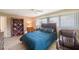 Comfortable bedroom with blue accents, and a bookshelf for storage and displaying decor at 13821 Joyce Dr, Largo, FL 33774