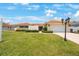 Charming home with a well-manicured lawn and a driveway leading to an attached garage at 13821 Joyce Dr, Largo, FL 33774