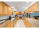 Bright kitchen with modern appliances, wooden cabinets, granite counters and an open floor plan at 13821 Joyce Dr, Largo, FL 33774